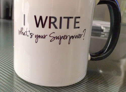 A mug that says "I Write, whats your superpower?"